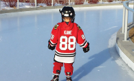 Little Boy Ice Skating in a Hockey Uniform