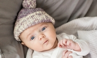 Baby wearing knitted hat.