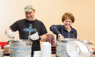 Richard and Carla Bahr, founders of nonprofit Threshold to New Life, serve food to people experiencing homelessness.