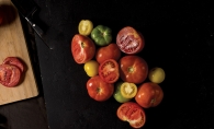 Colorful tomatoes on a black background.