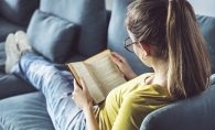 A woman reading "Beauty of the Moment" by Tanaz Bhathena