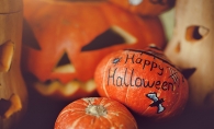 A pumpkin painted with the words "Happy Halloween" at the Maple Grove Arts Center Monster Art Show.