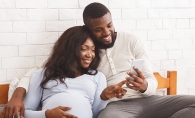 Pregnant couple counting baby's kicks in utero