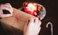 A volunteer wraps a gift for the Be a Santa to a Senior program.