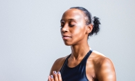 A woman practices Breathwork.