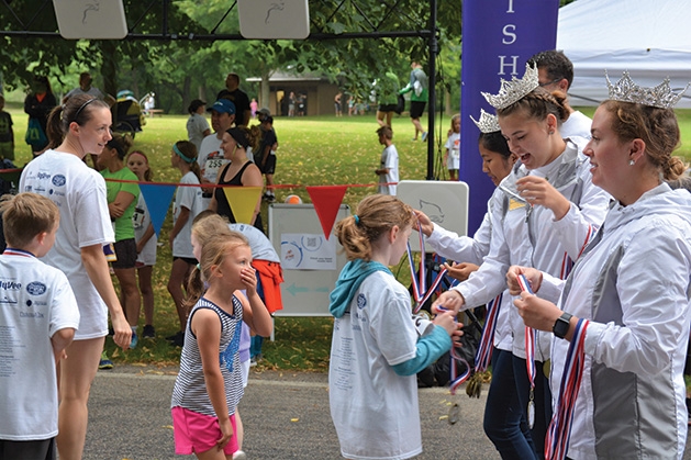 Medals are royally handed out at the finish line at the 9th annual Reading is Fun 5K