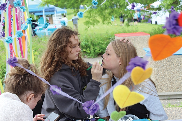 A girl gets her face painted at the Feeding Furry Friends Family Fun Day.