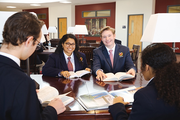 A group of students gathered at a table at Parnassus Preparatory School in Maple Grove.