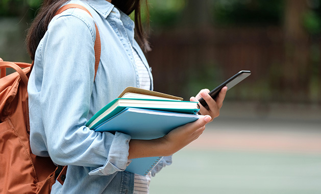 A woman reads a parenting book about school.