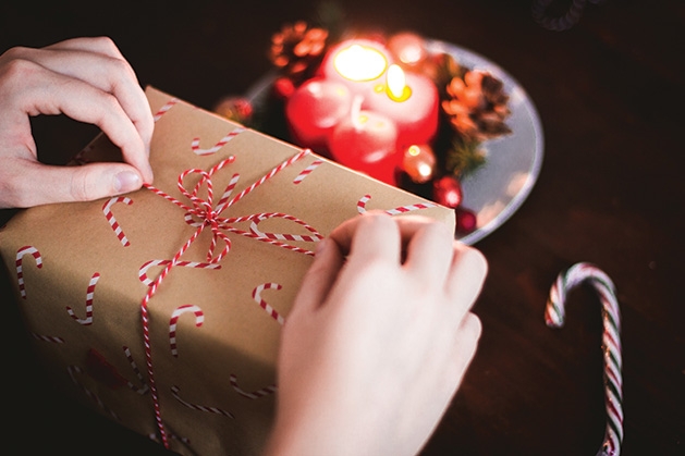 A volunteer wraps a gift for the Be a Santa to a Senior program.