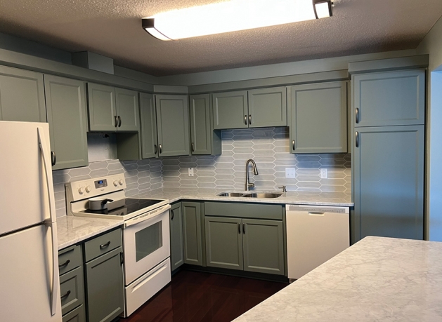 Sage green kitchen cabinets.