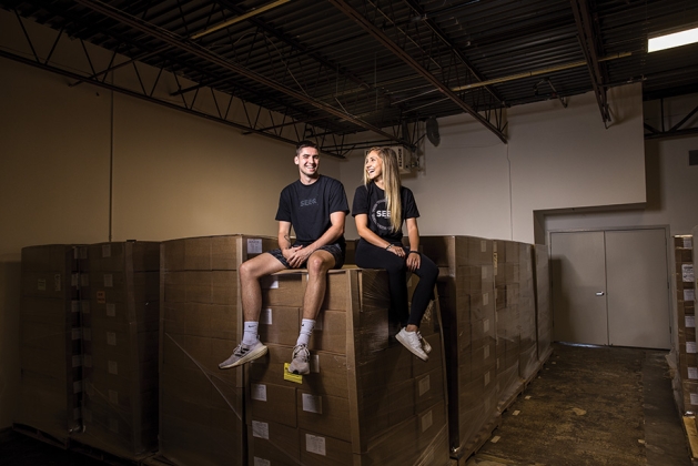 Founders of Seeq Supply,  Ben Zaver and Hannah Perez, among pallets of Seeq. 