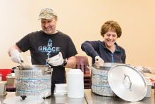 Richard and Carla Bahr, founders of nonprofit Threshold to New Life, serve food to people experiencing homelessness.