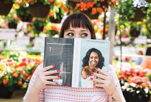 A woman holds a copy of "Becoming" by Michelle Obama