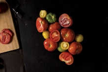 Colorful tomatoes on a black background.
