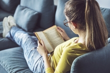 A woman reading "Beauty of the Moment" by Tanaz Bhathena