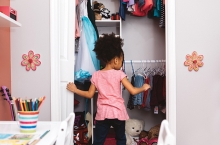 A child cleans their closet.