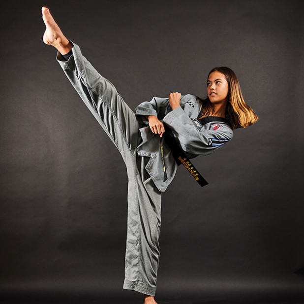 Osseo Middle School student Jessica Lee reaches for new heights with her taekwondo kick. 