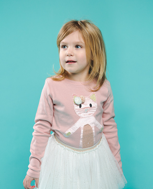 A child models clothing from Oh Baby!