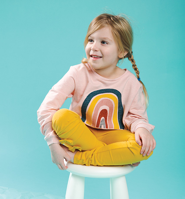 A child models clothing for Oh Baby!
