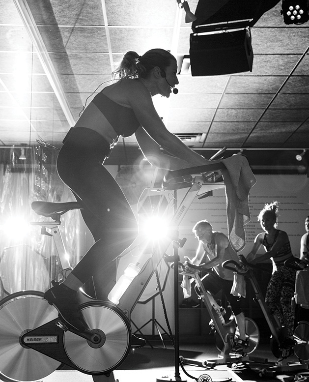 An instructor leads a cycling class at Surge Cycling in Maple Grove.