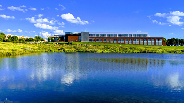 A building in Maple Grove reflected in the water.