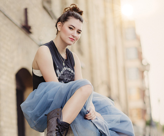 A girl poses for a senior picture taken by Any Angle Photography