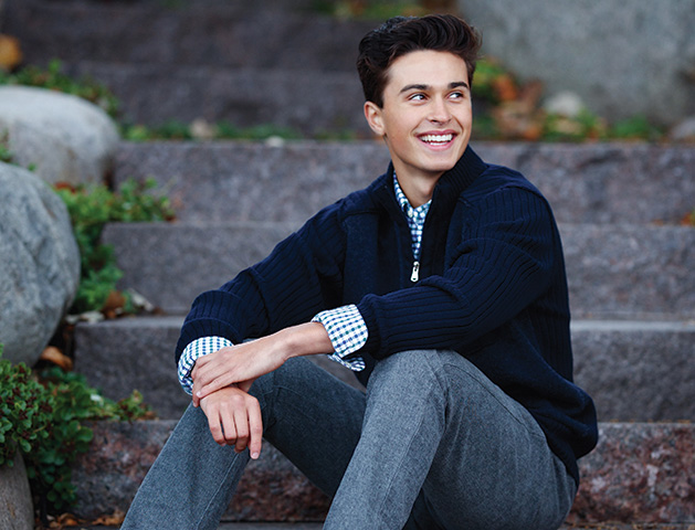 A boy poses for a senior picture taken by Any Angle Photography